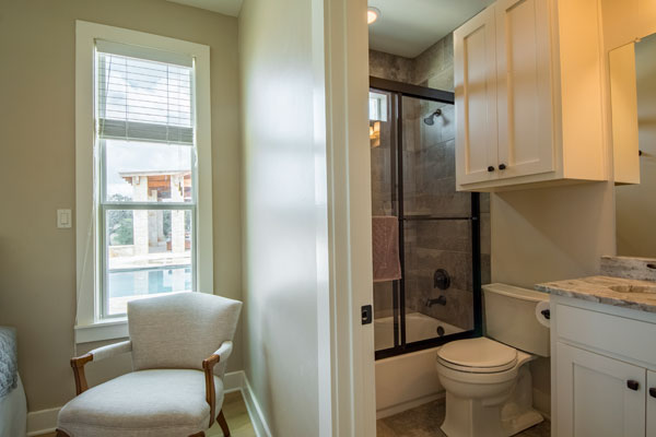 Bedroom With Private Bath and Pool Views